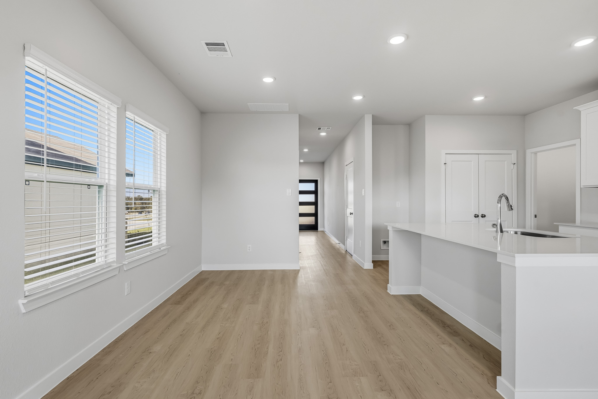 A kitchen with white cabinets.