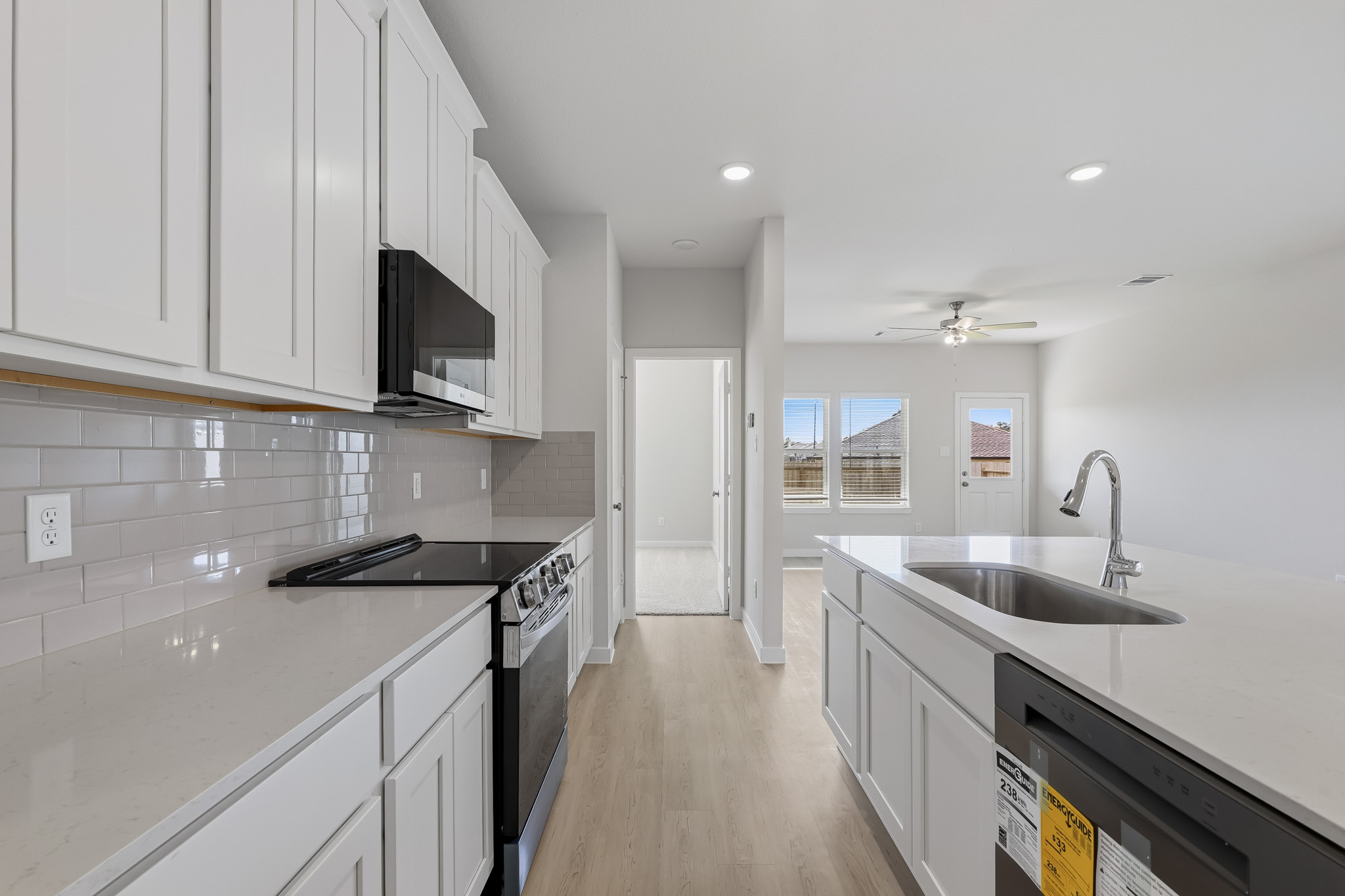 A kitchen with white cabinets.