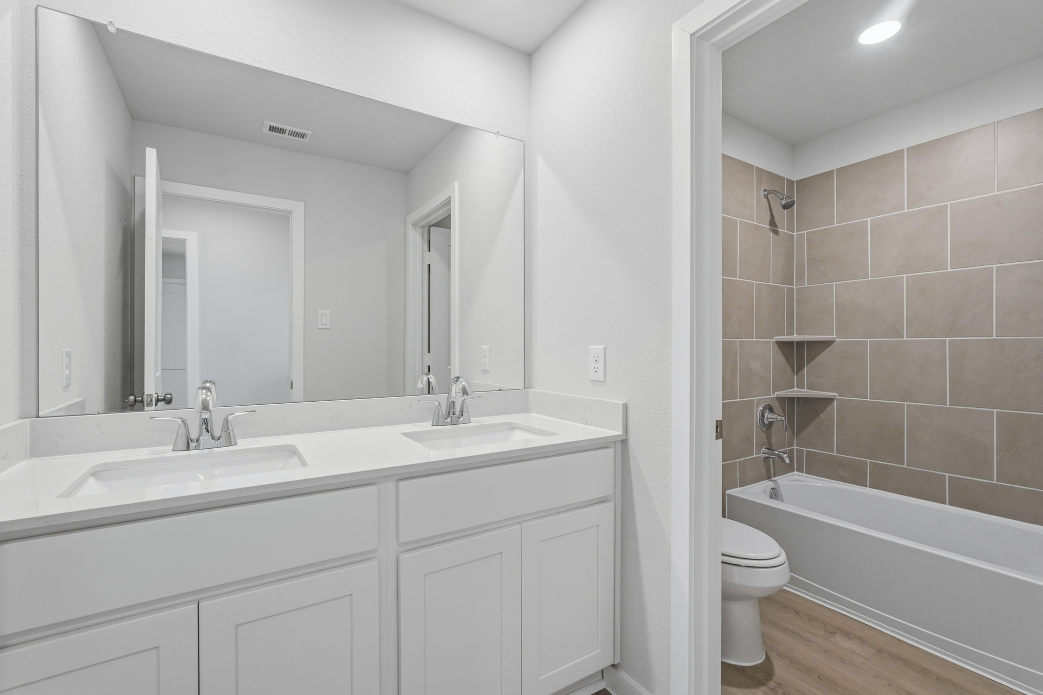 A bathroom with a tub sink and toilet.