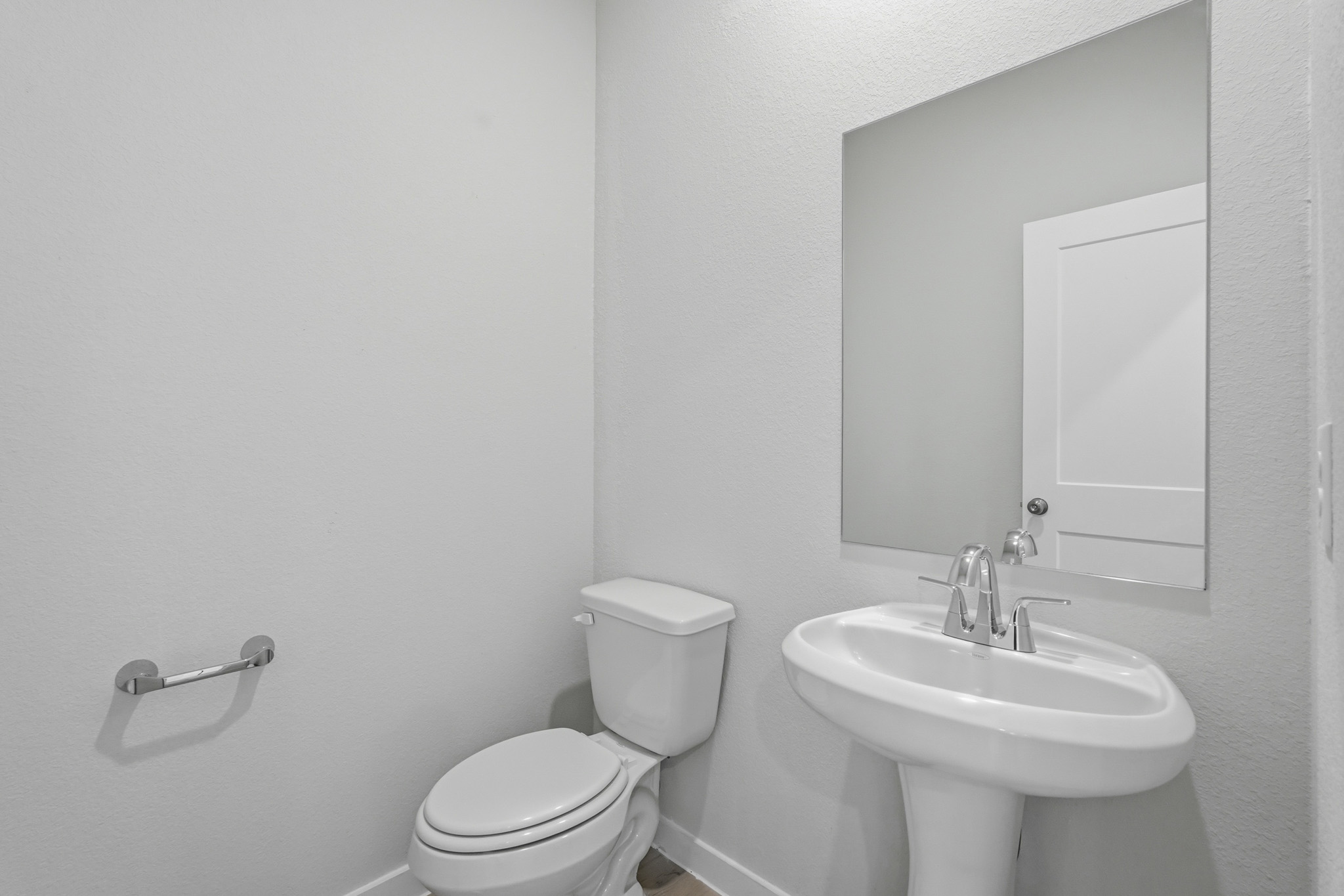 A bathroom with a toilet and sink.