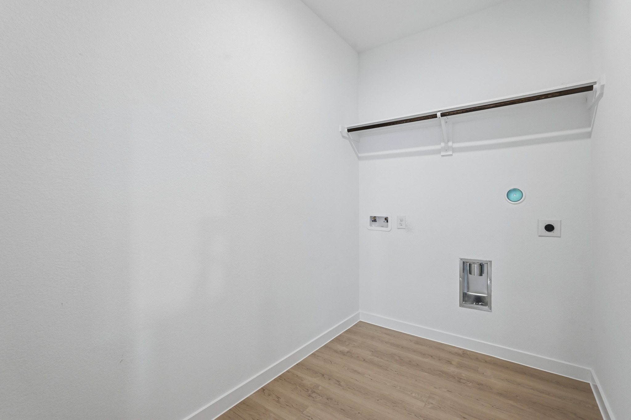 A white wall with a light on it.