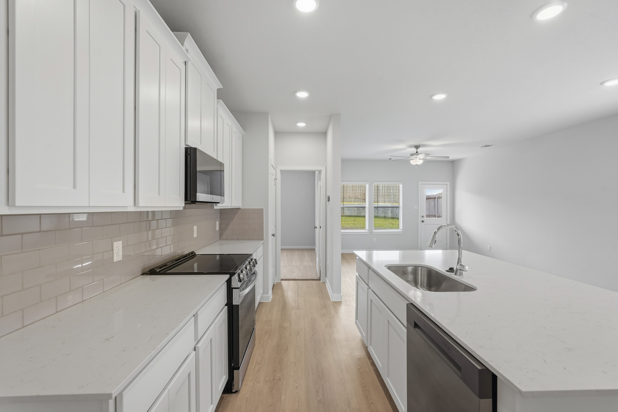 A kitchen with white cabinets.