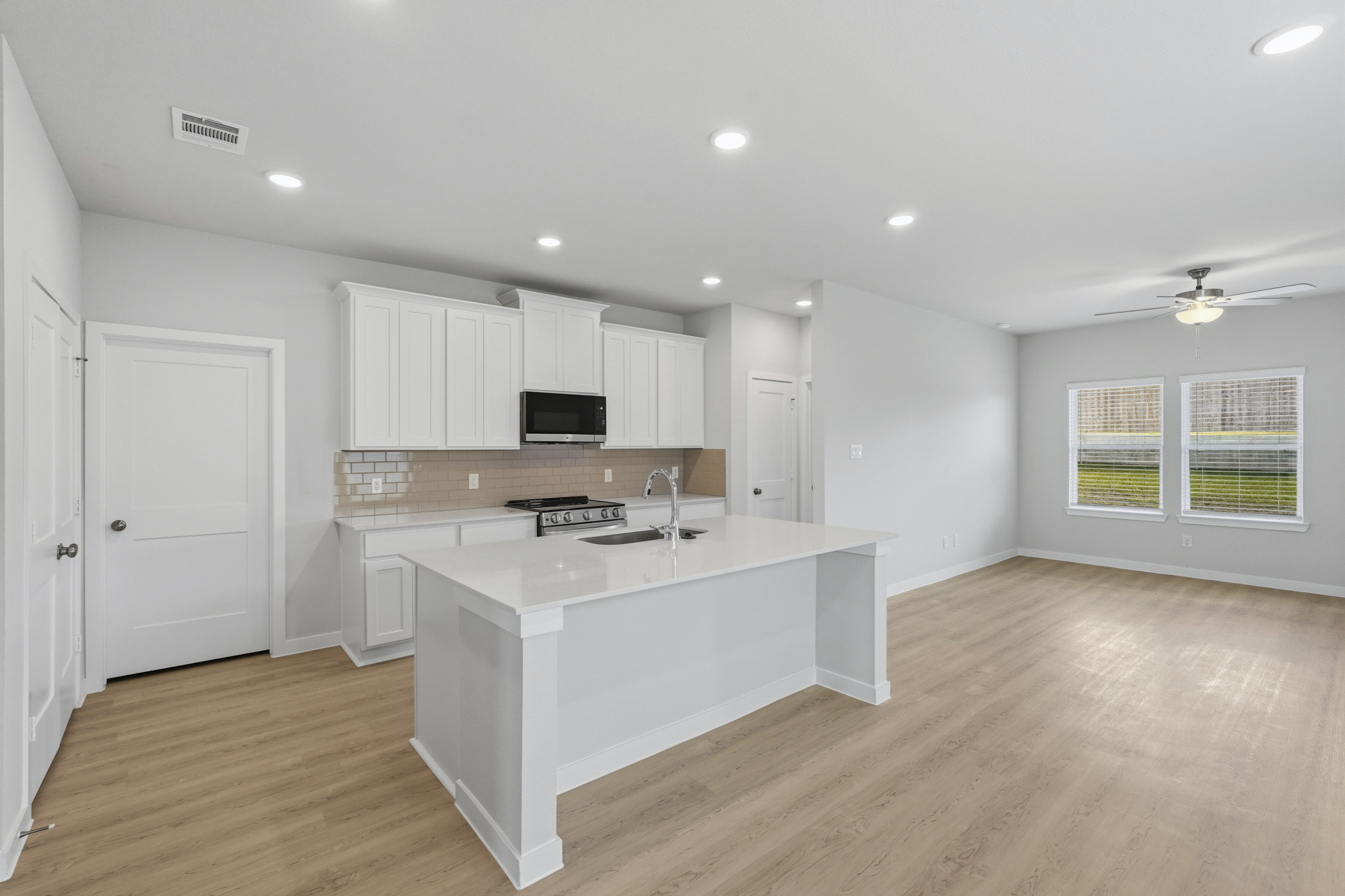 A kitchen with white cabinets.