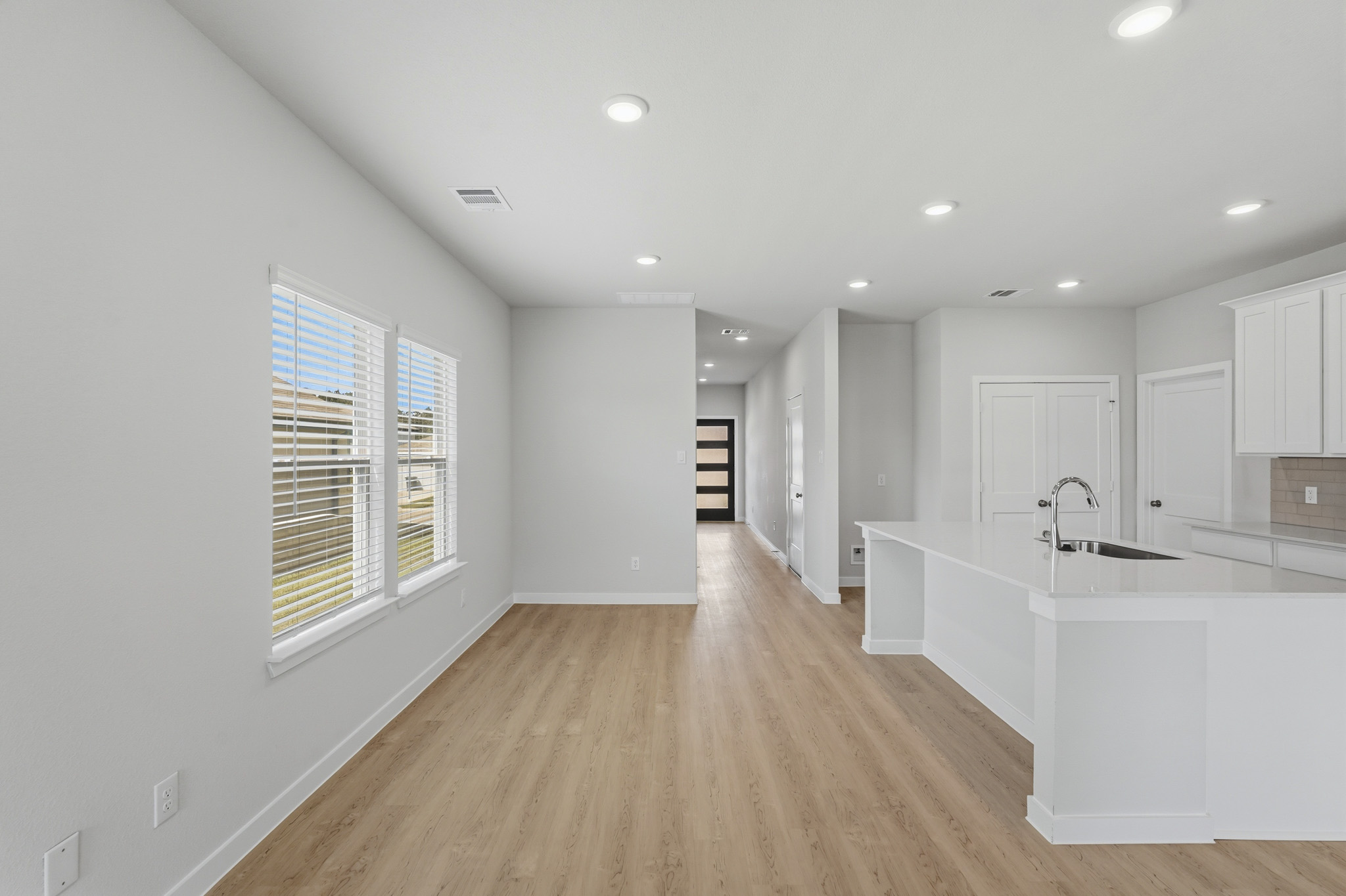 A kitchen with white cabinets.