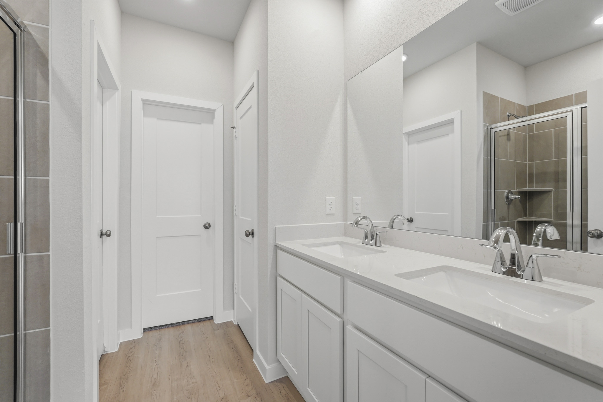 A bathroom with a large mirror.