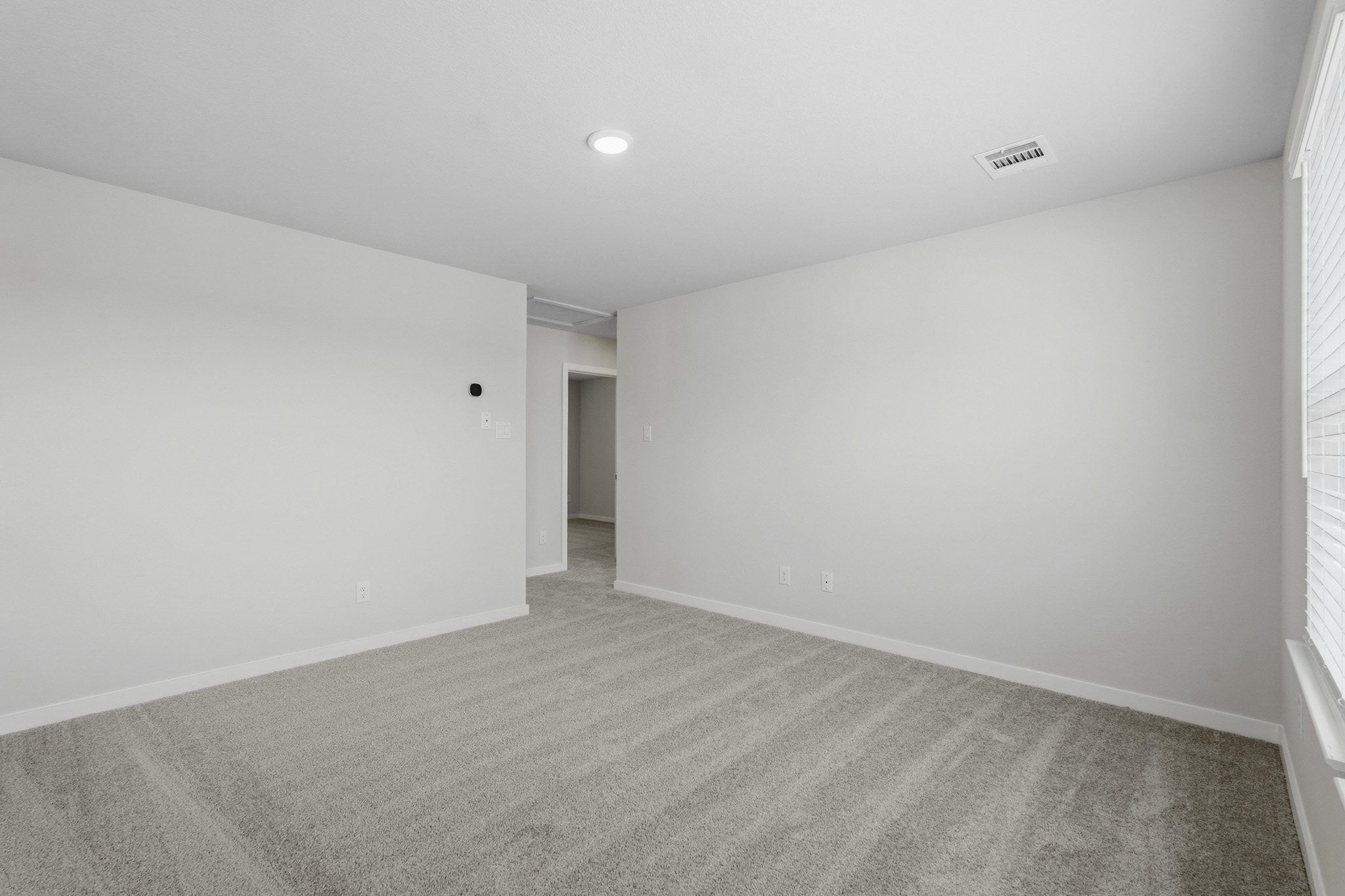 A hallway with white walls.