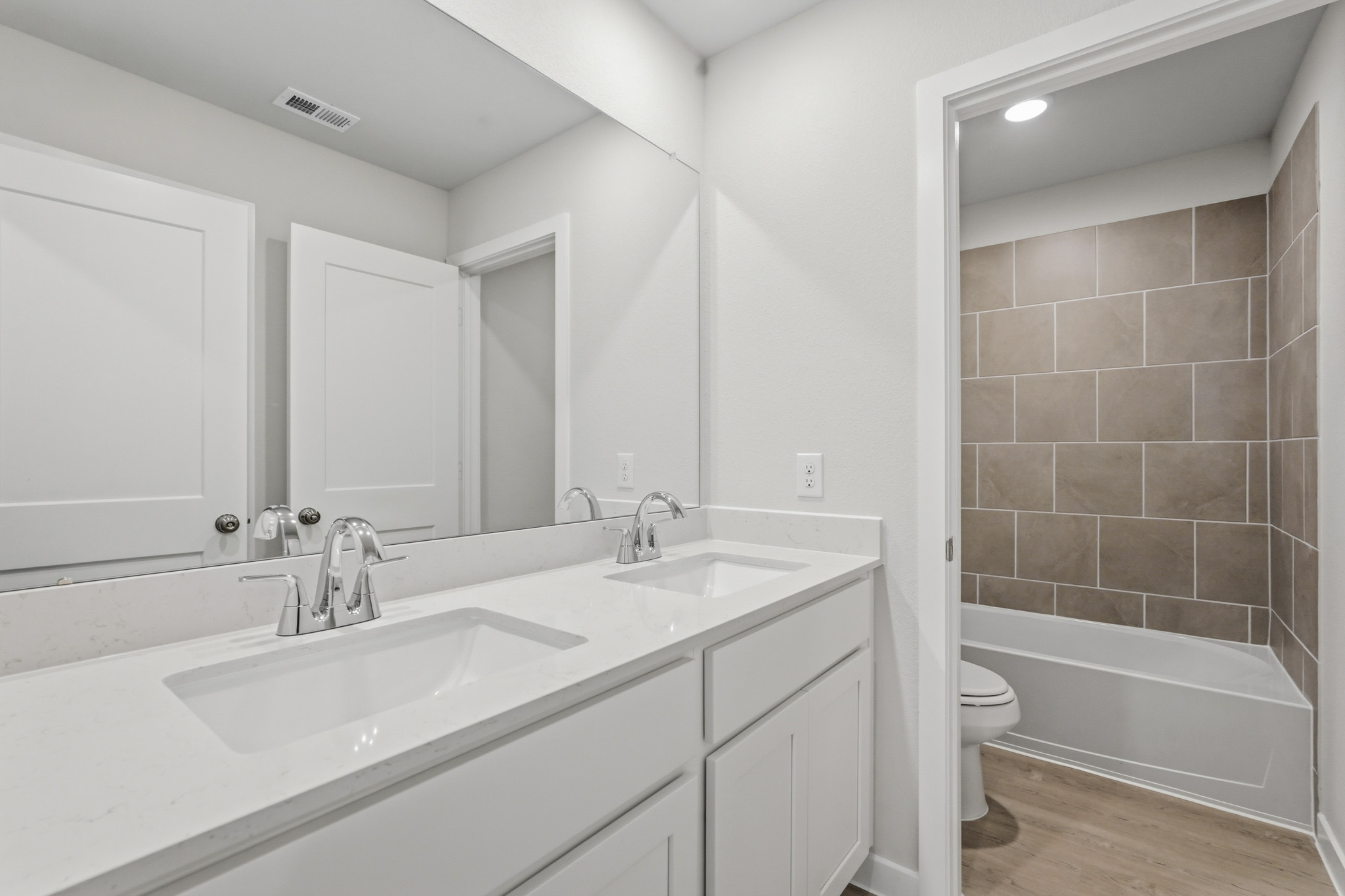 A bathroom with a tub sink and toilet.