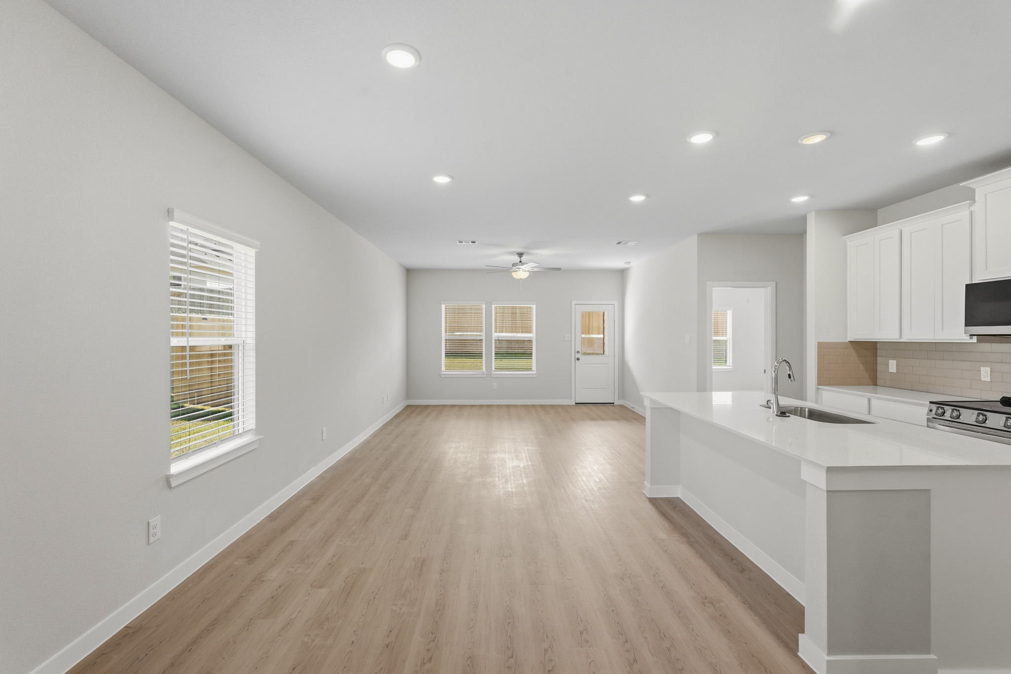 A kitchen with white cabinets.