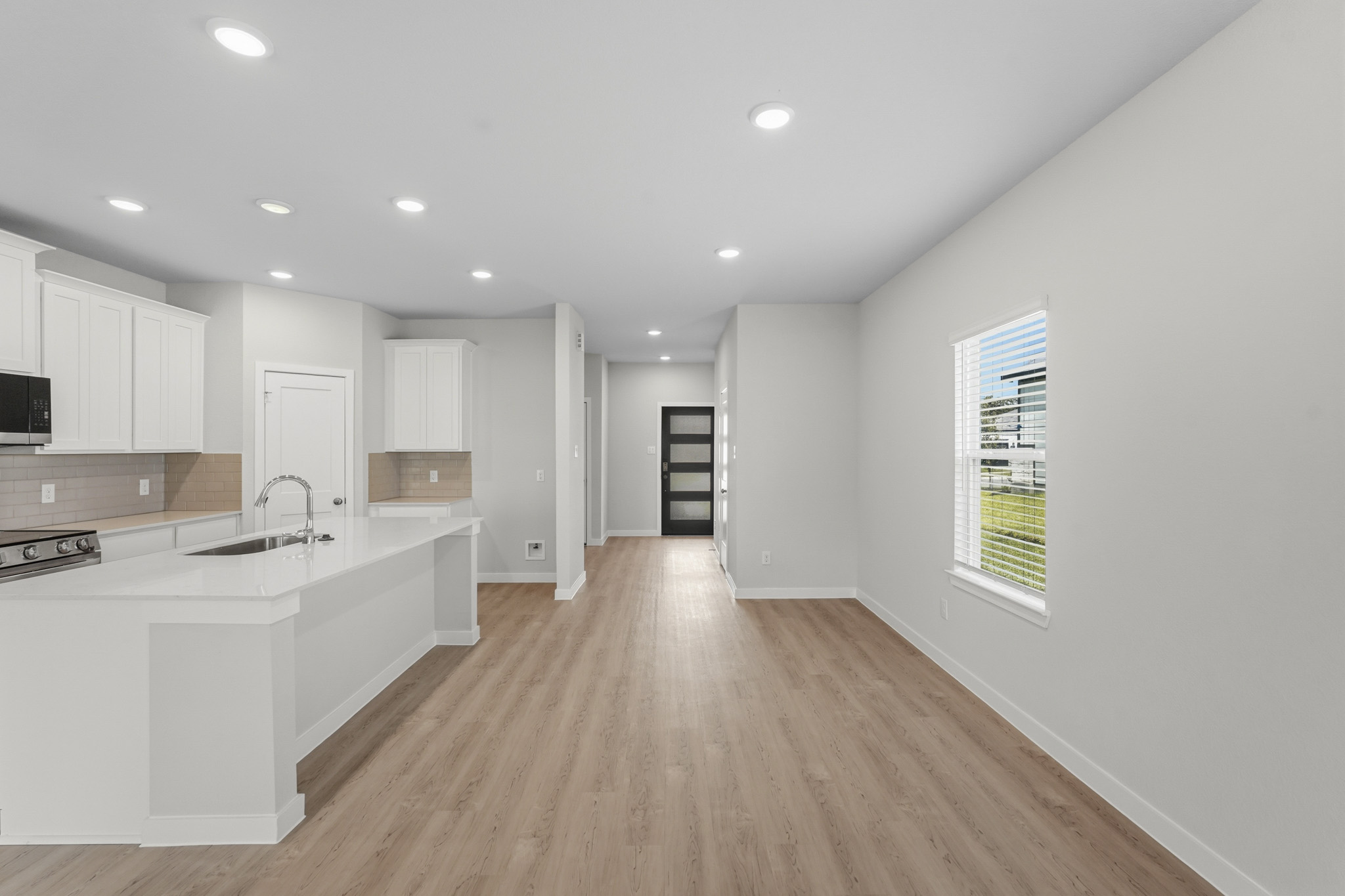 A kitchen with white cabinets.