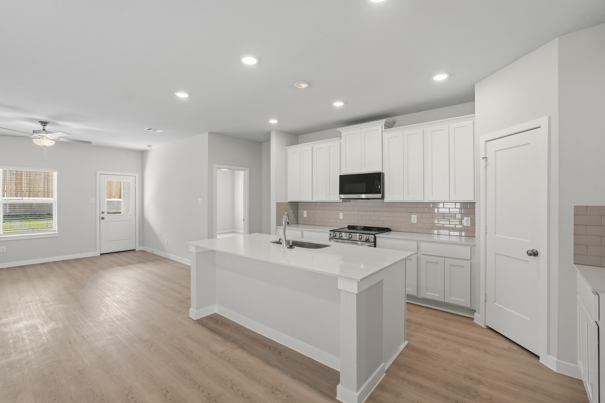 A kitchen with white cabinets.