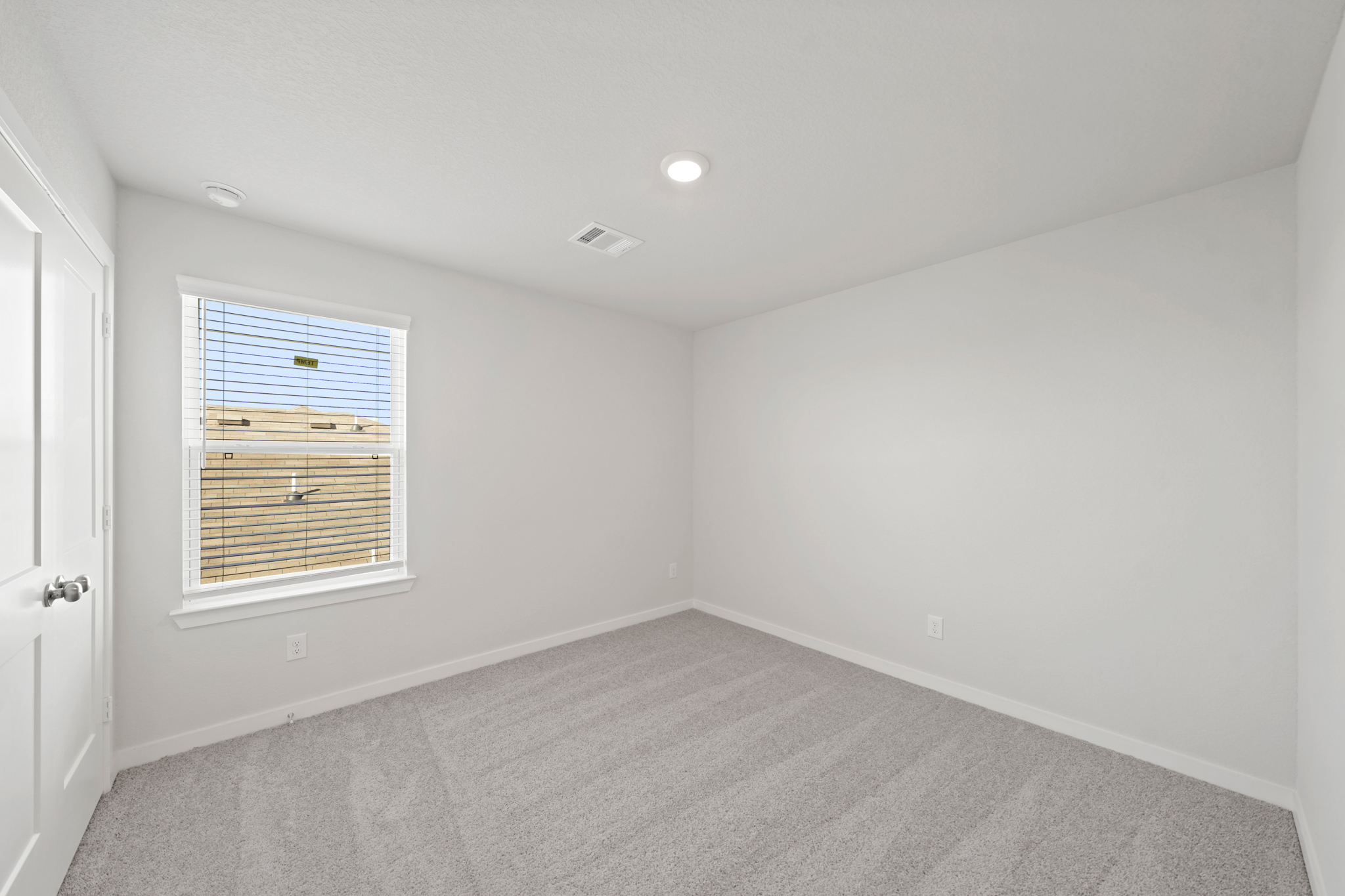 A room with a window and a door.