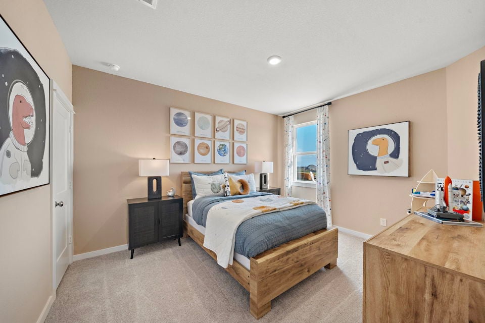 A bedroom with a bed and a bench.