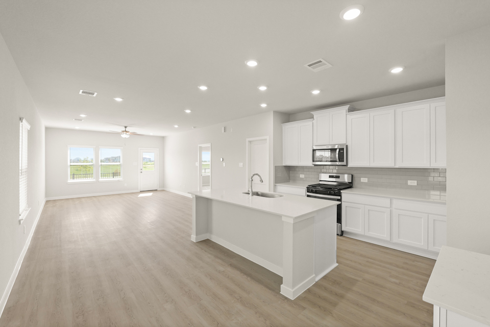 A kitchen with white cabinets.