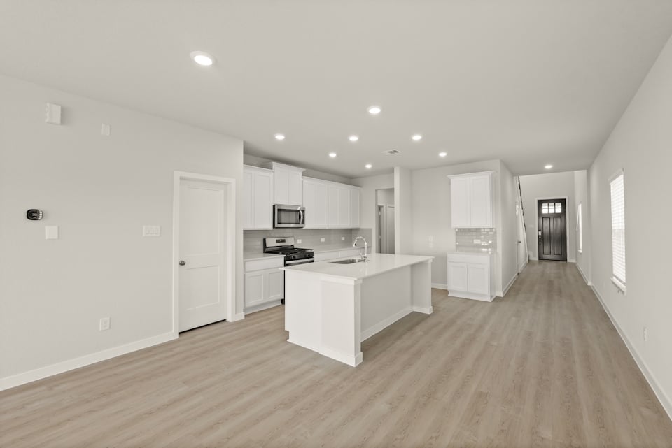 A large kitchen with white cabinets.