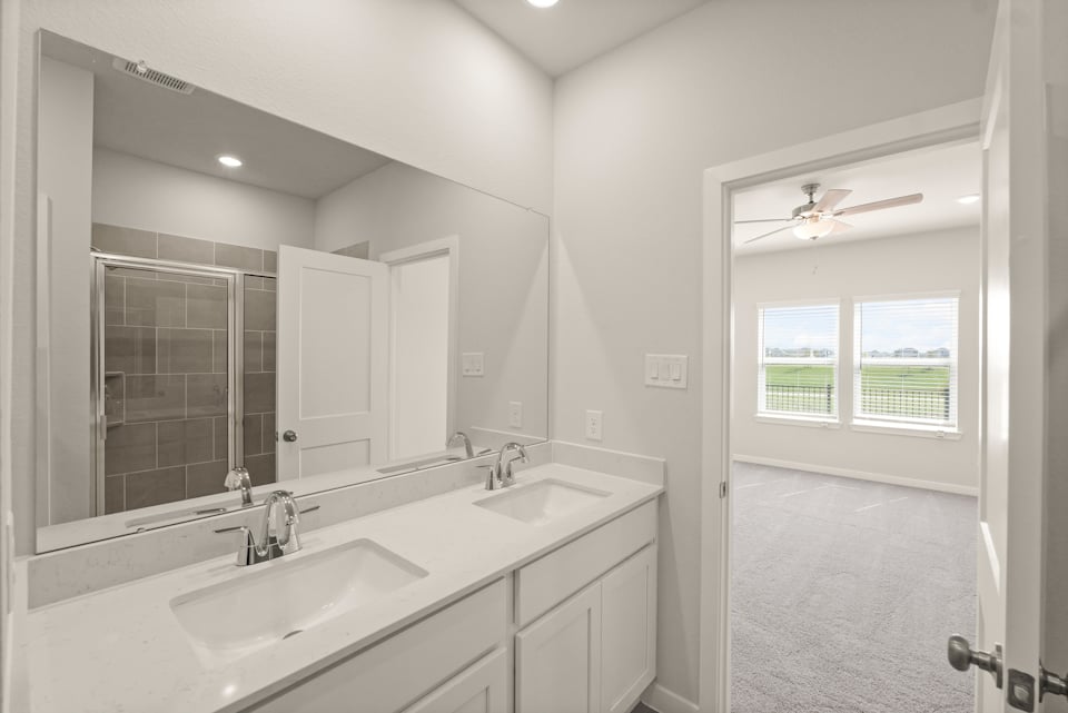 A bathroom with a large mirror.