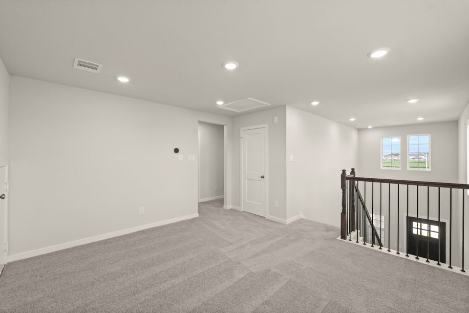 A room with a railing and a door.