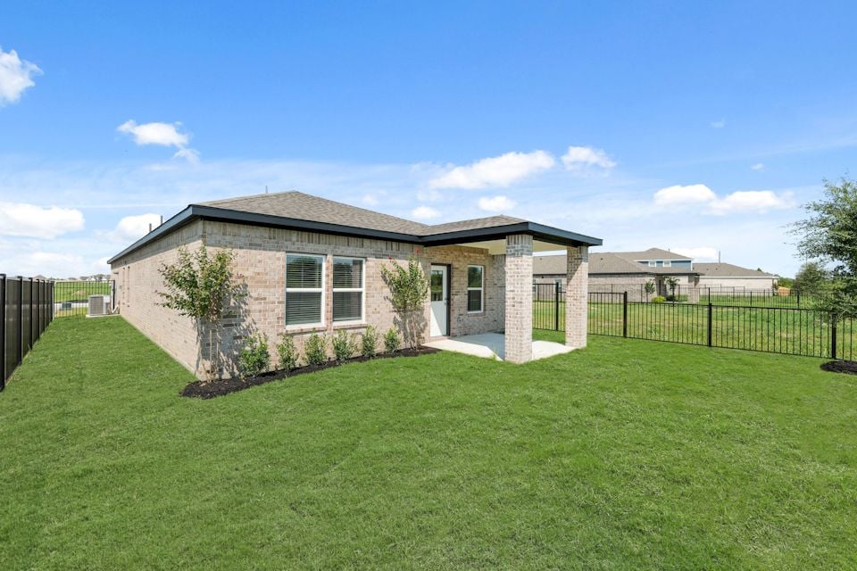 A house with a fence and trees.