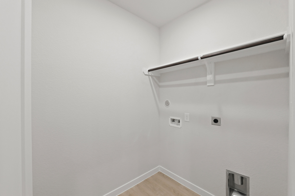 A white wall with a light fixture.