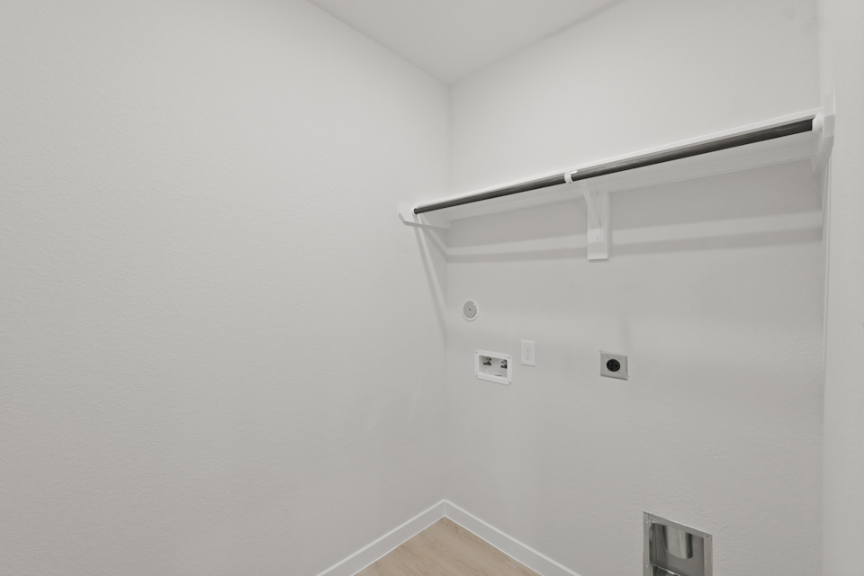 A white wall with a light fixture.