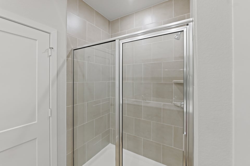 A shower with glass doors.