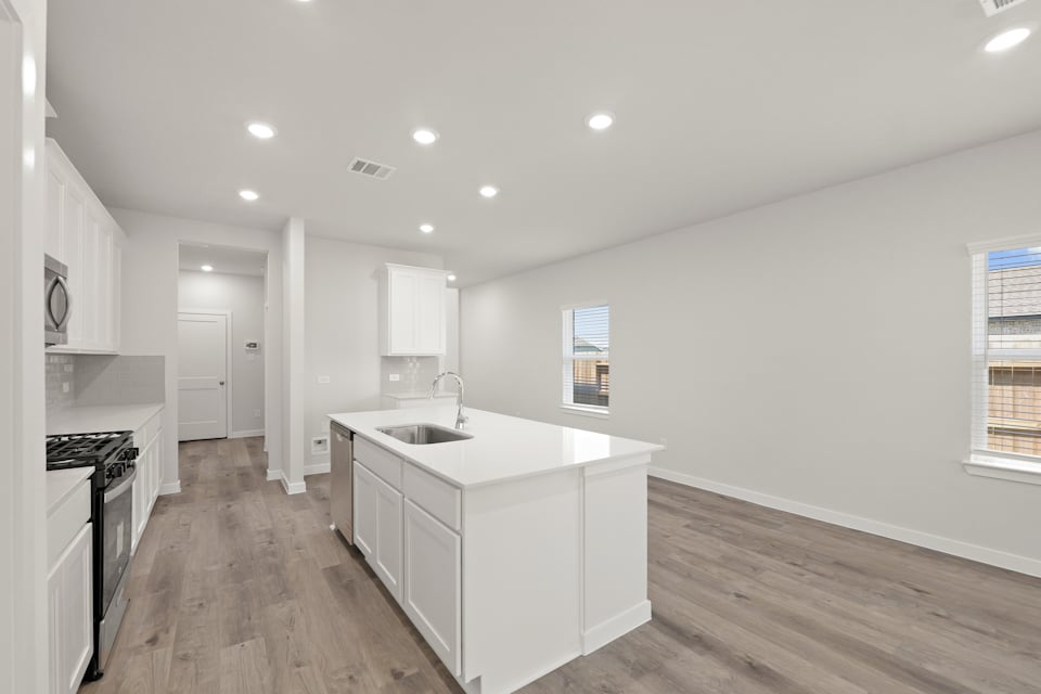 A kitchen with white cabinets.