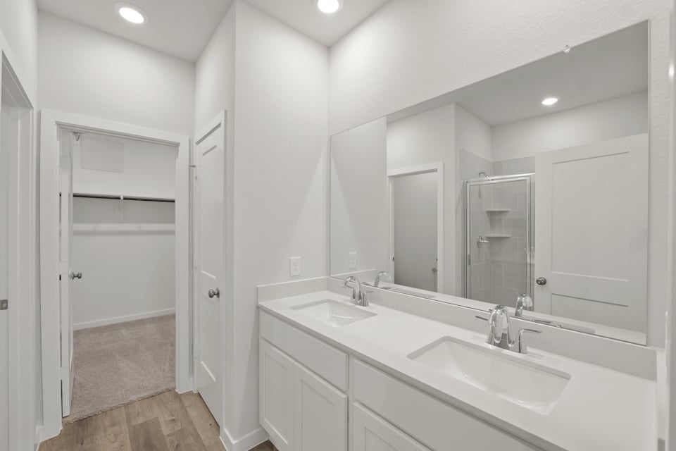 A bathroom with a large mirror.