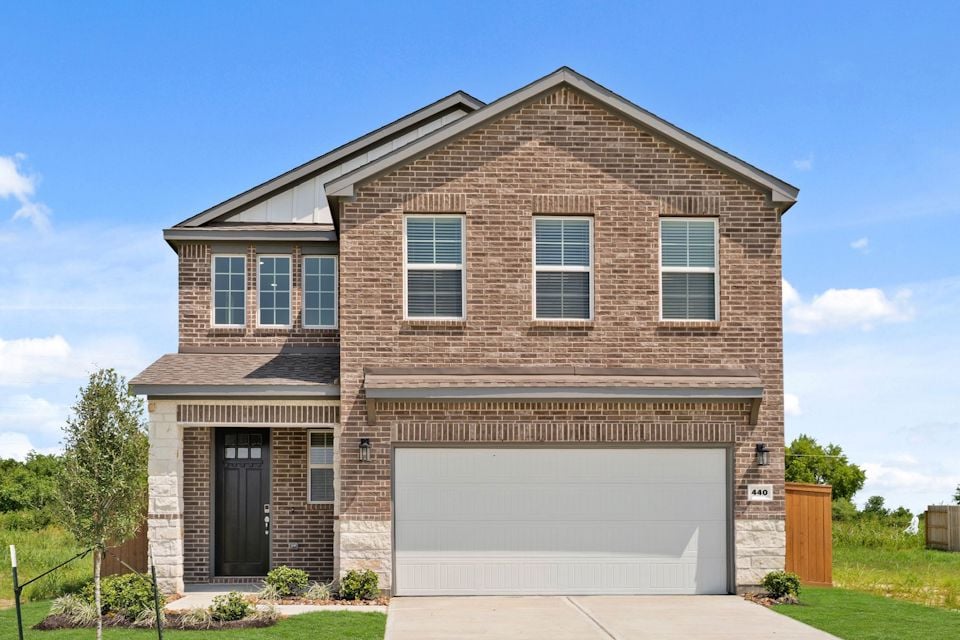 A brick building with a garage.