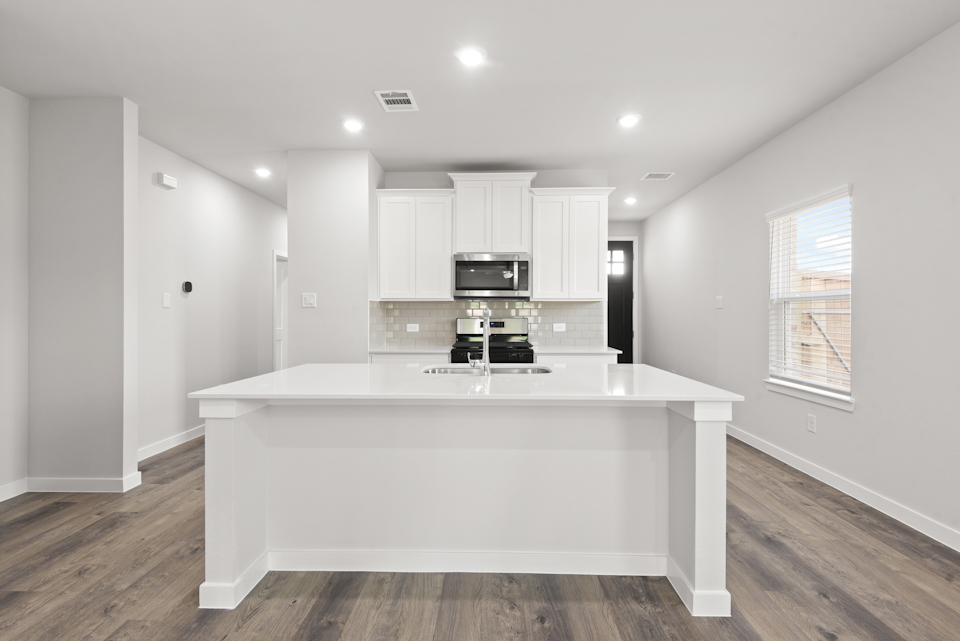 A white kitchen with a white counter.