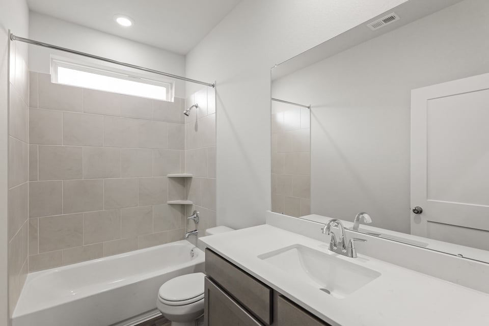 A bathroom with a tub sink and toilet.