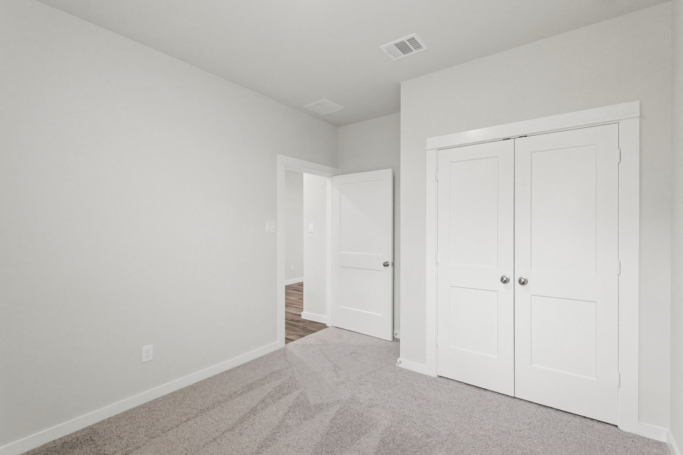 A hallway with white doors.
