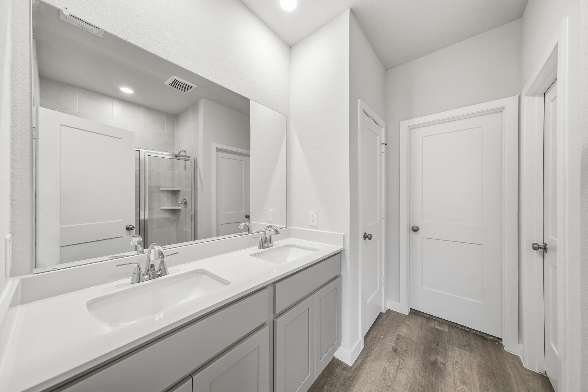A bathroom with a large mirror.