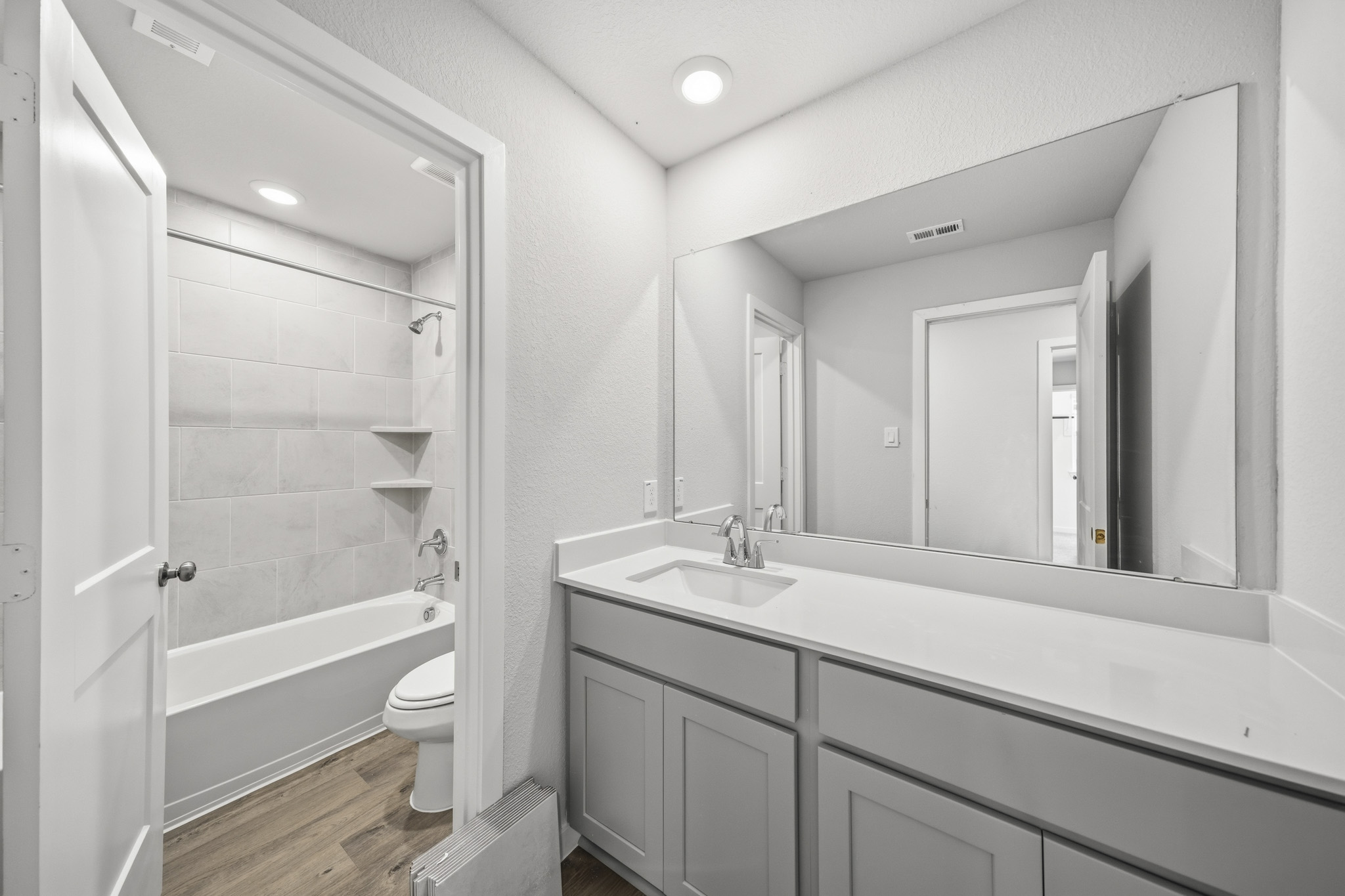 A bathroom with a tub sink and toilet.
