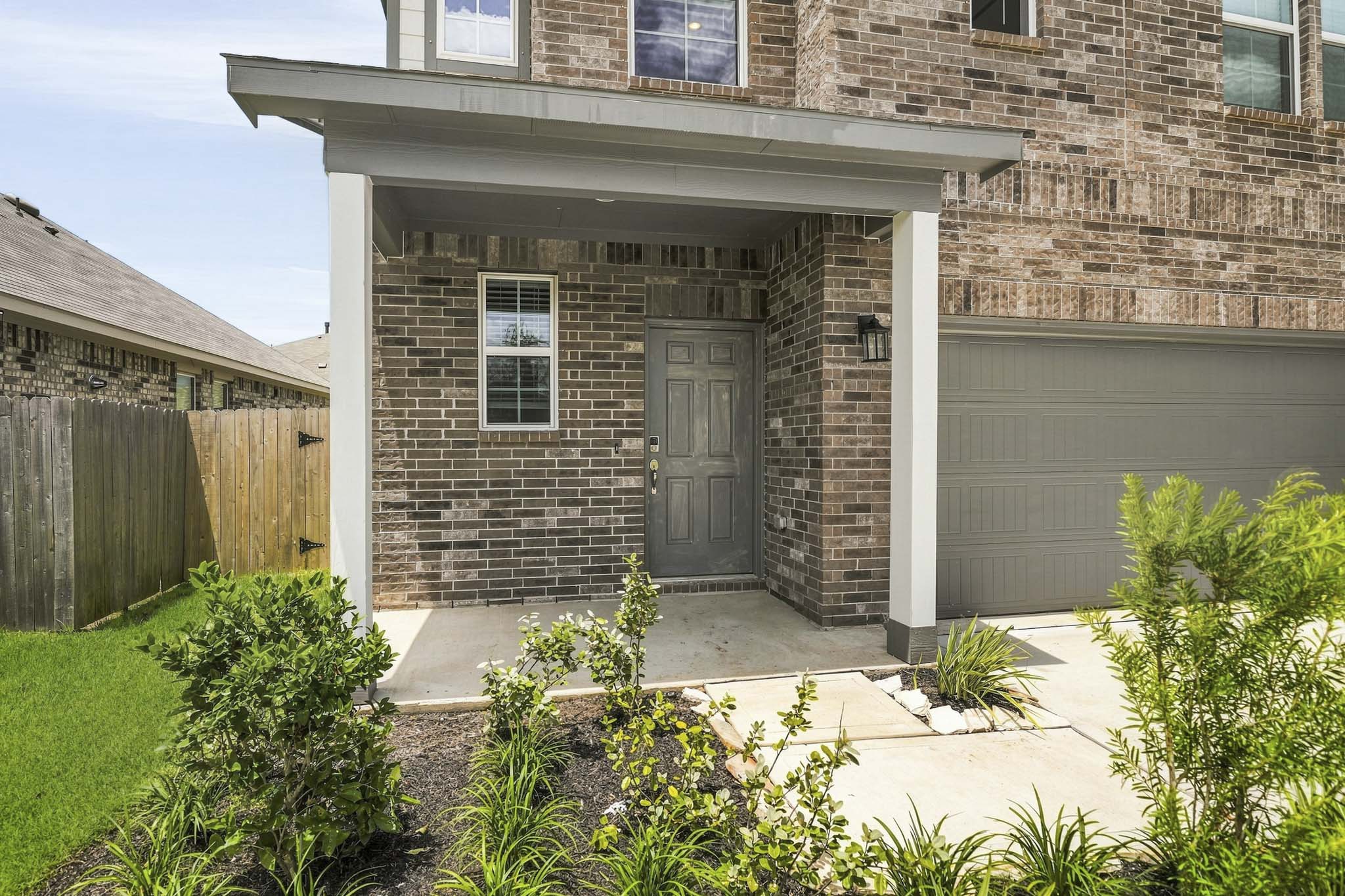 A house with a garage and a fence.
