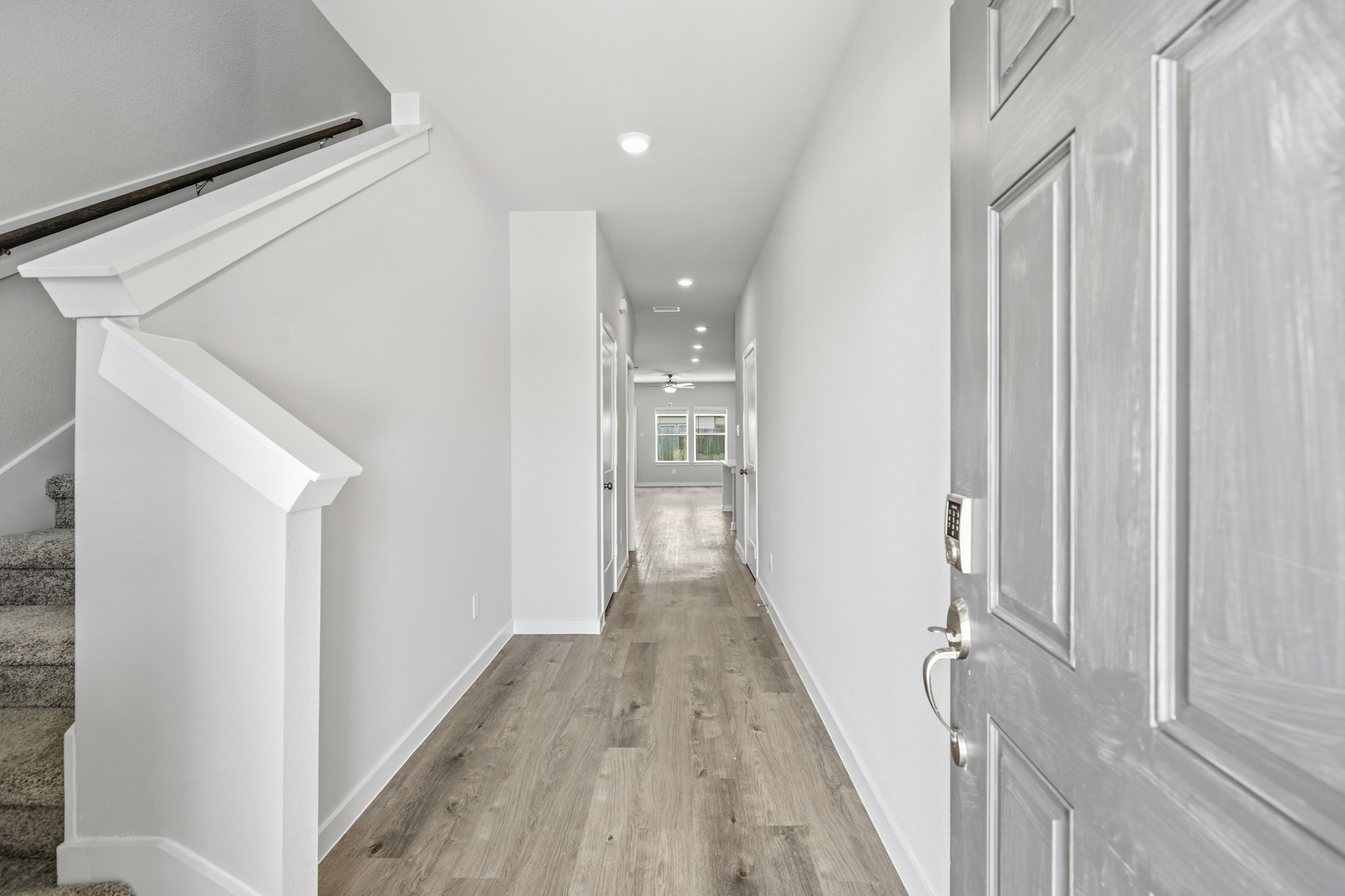 A hallway with white walls.