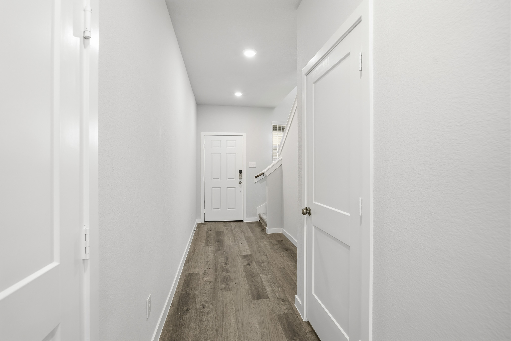 A hallway with white doors.