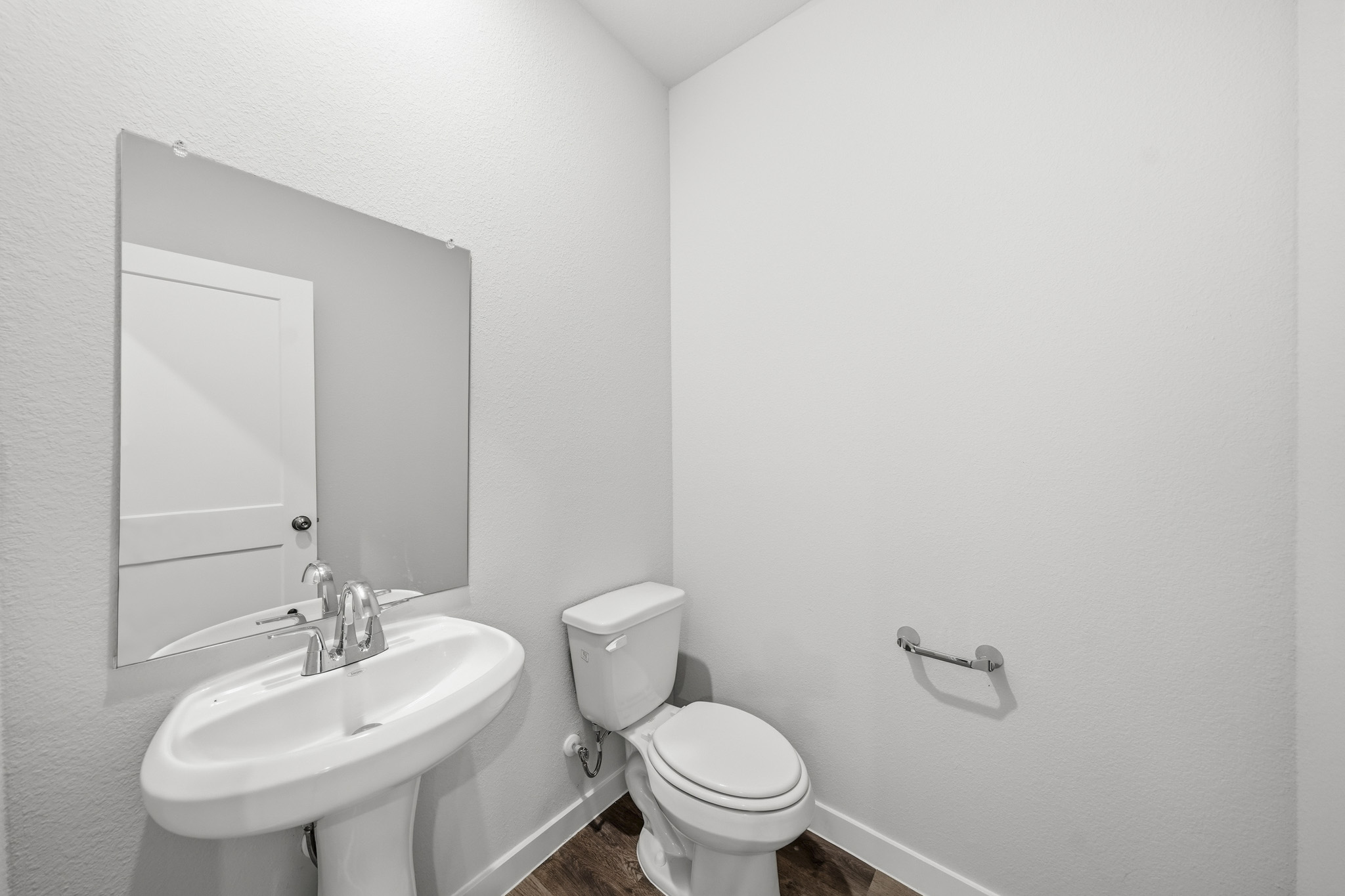 A bathroom with a toilet and sink.
