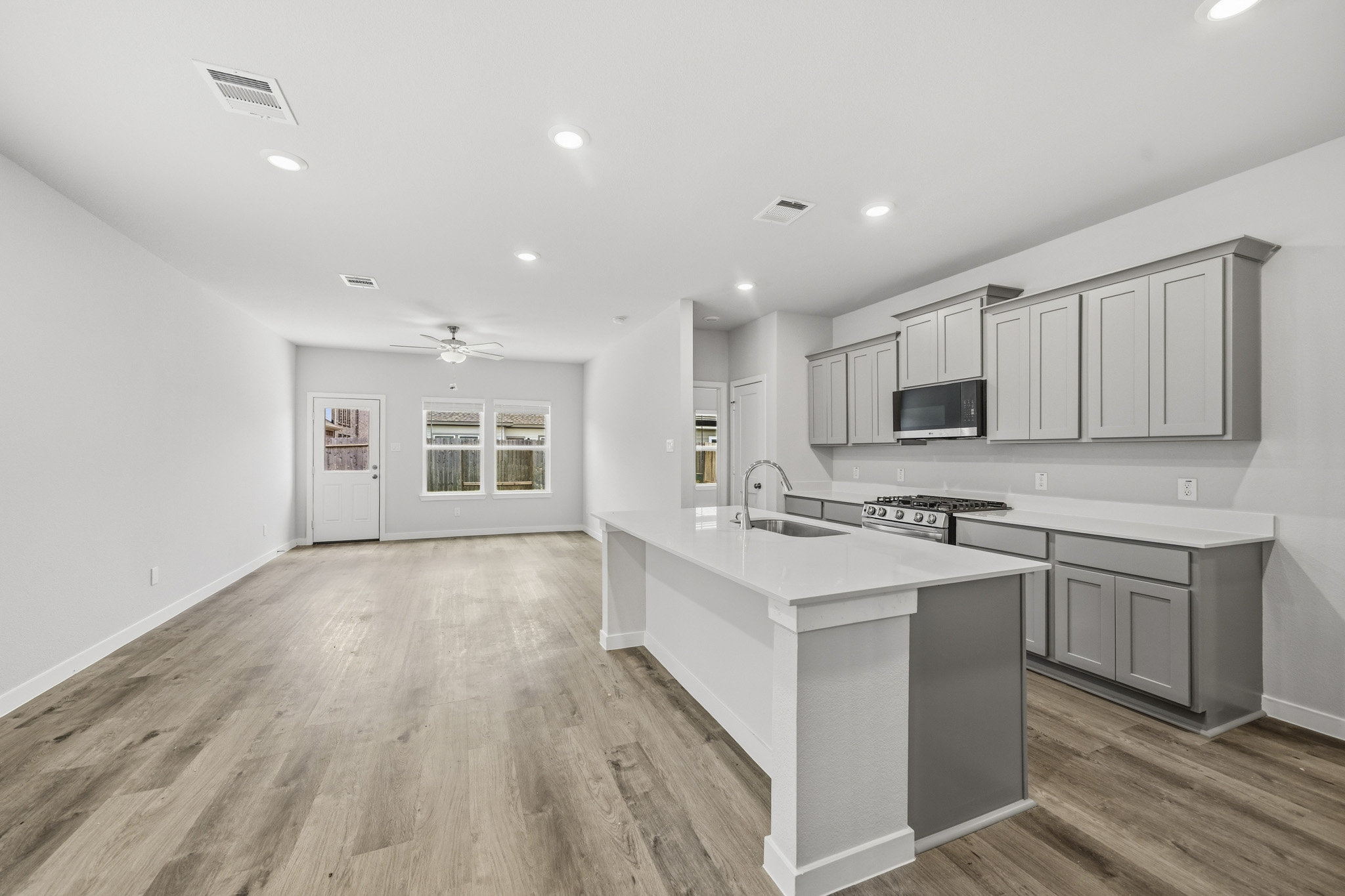 A kitchen with white cabinets.