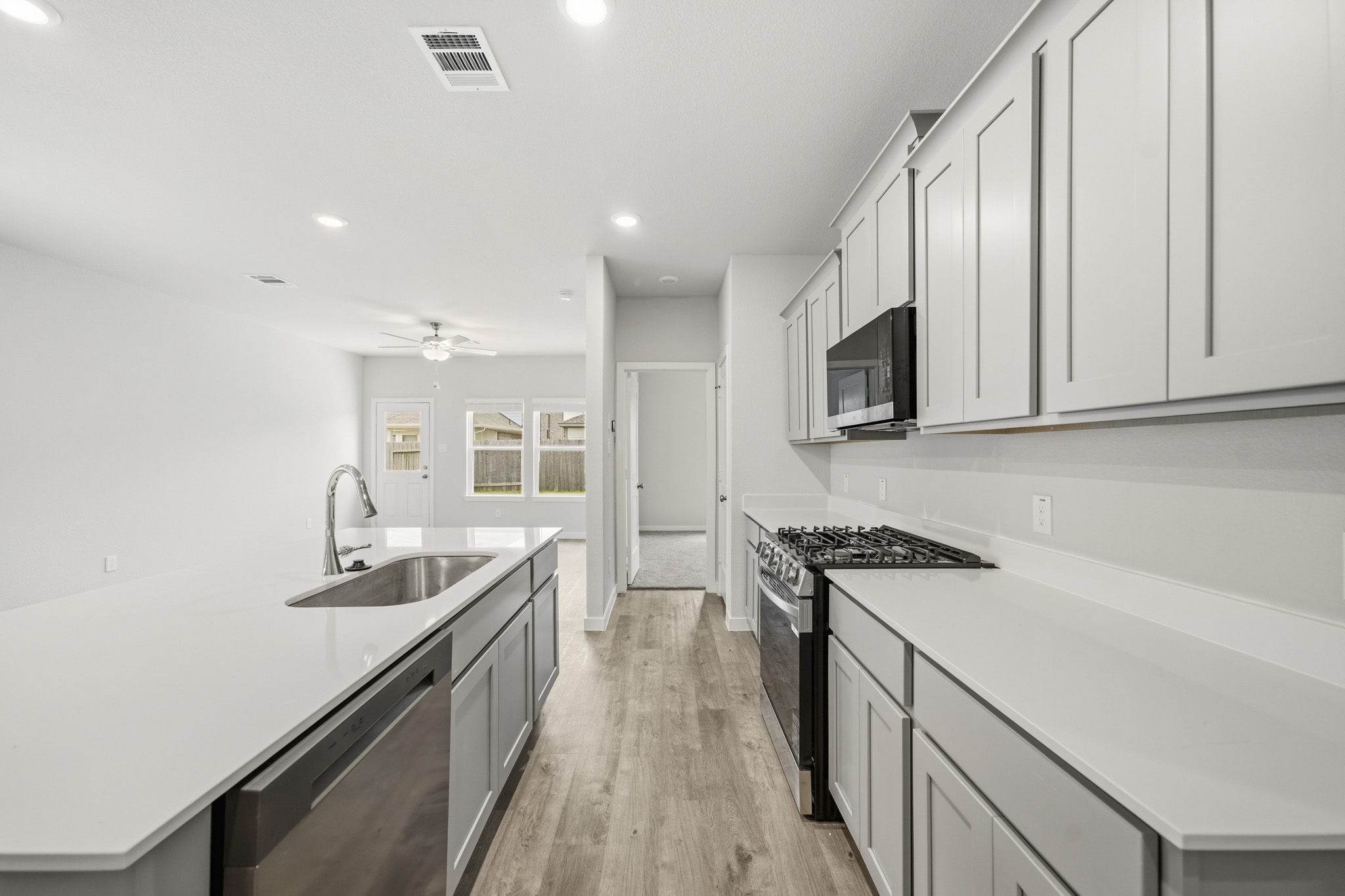 A kitchen with white cabinets.