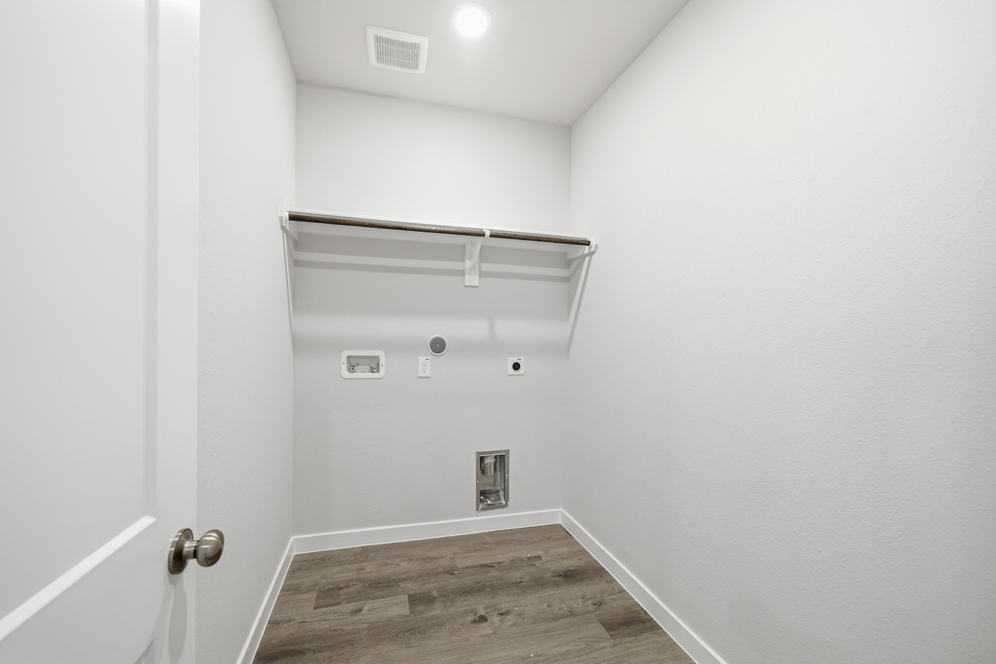 A white room with a wood floor.