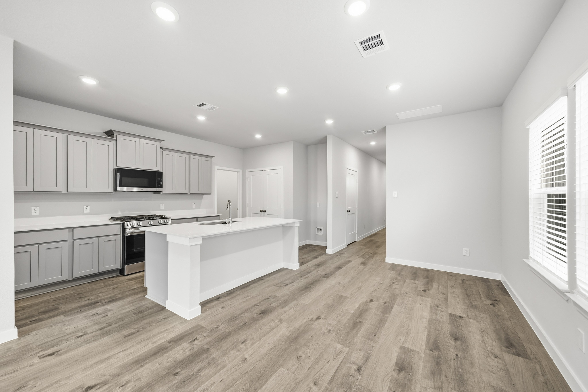 A kitchen with white cabinets.