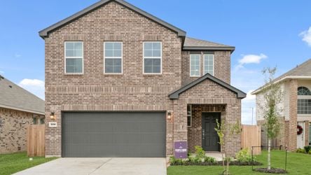 A brick house with a garage.