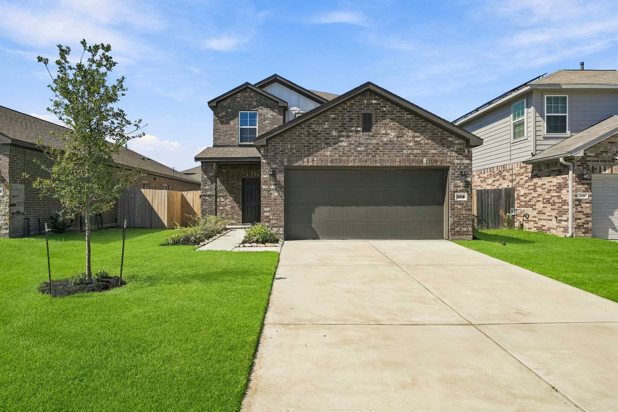 A driveway leading to a house.