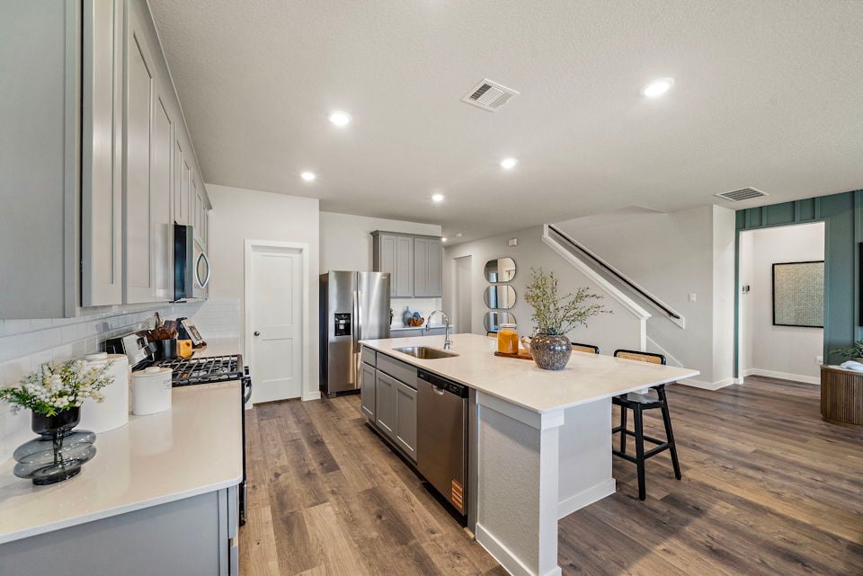 A kitchen with white cabinets.