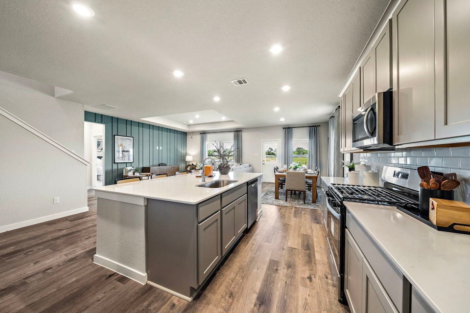 A kitchen with a wood floor.