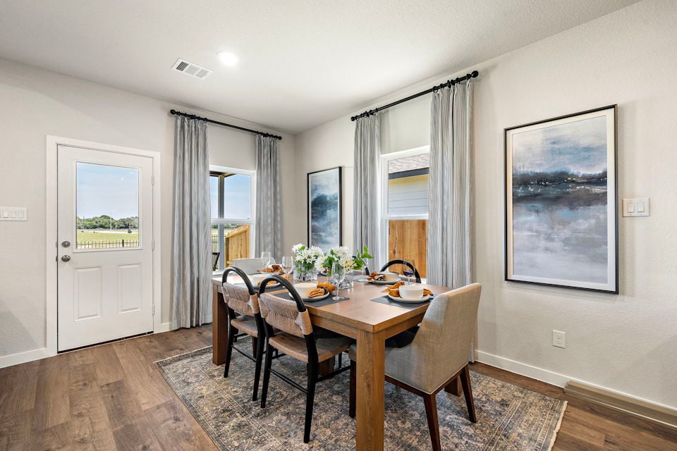 A dining room table with chairs.