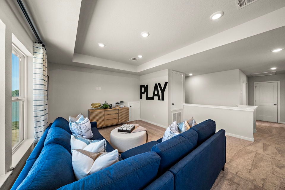 A living room with blue couches.