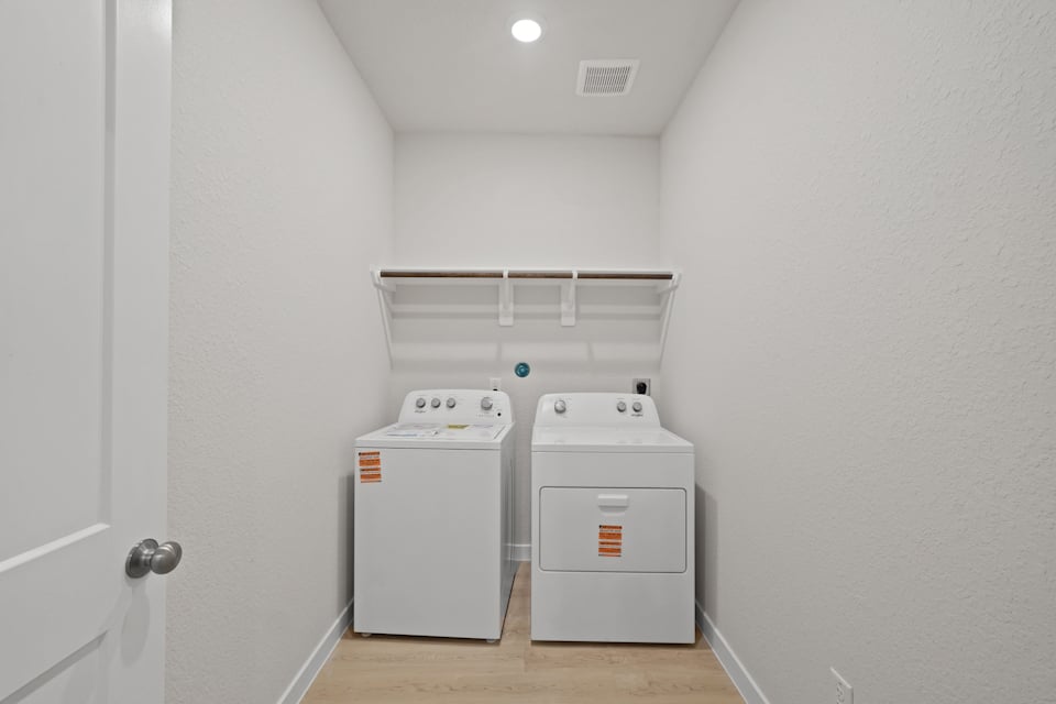 A laundry room with a washer and dryer.
