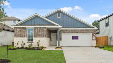 A house with a garage with American Gothic House in the background.
