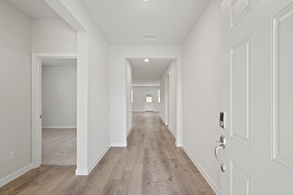 A hallway with white doors.