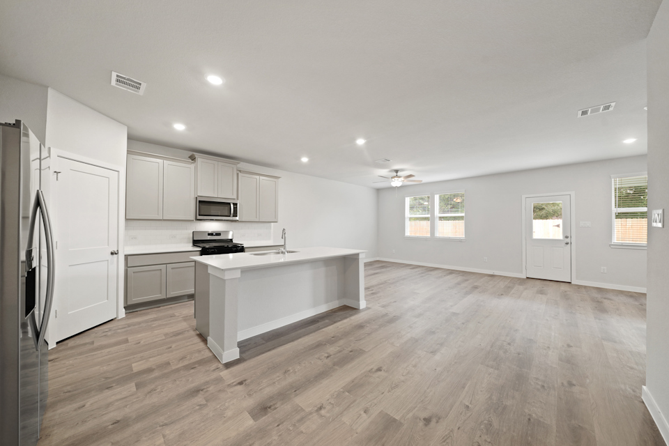 A kitchen with white cabinets.